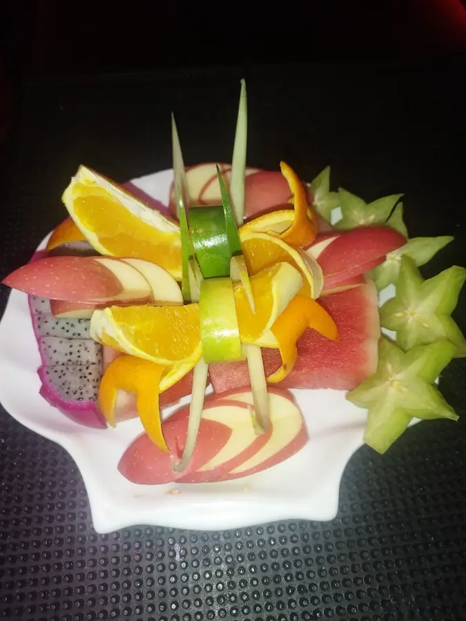 Crown KTV: Decorative cut-fruit platter (orange, apple, watermelon, dragon fruit, starfruit)