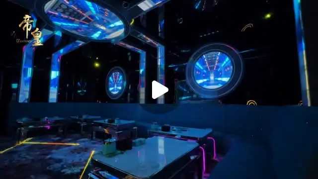 D'Emperor KTV (帝皇): KTV room interior with blue LED tunnel-style lighting, round screens and tables (reel frame, play icon overlay)